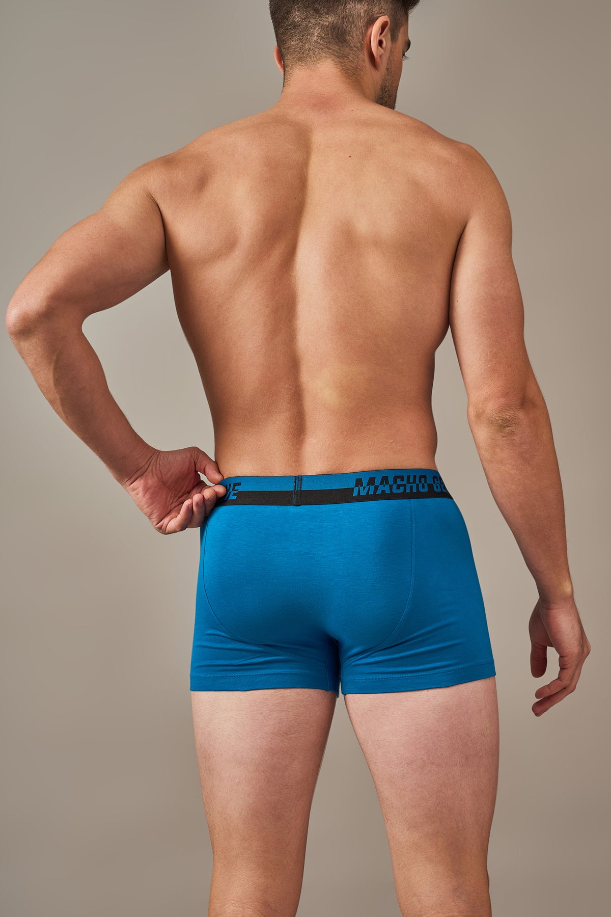 Macho Genie men's lagoon blue trunks shown from the back, highlighting the comfortable 3-inch inseam, smooth waistband, tailored fit and no-ride-up construction