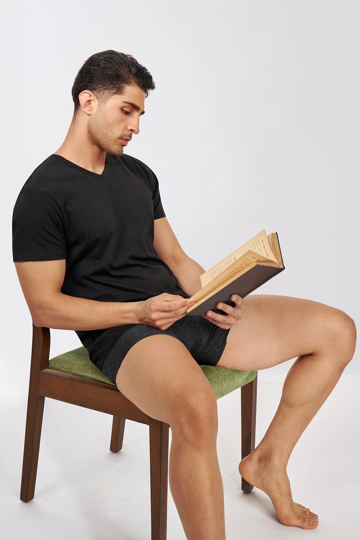 Man wearing a Macho Genie AeroCot Base+ black V-Neck undershirt for relaxed everyday wear, highlighting its lightweight breathable cotton comfort