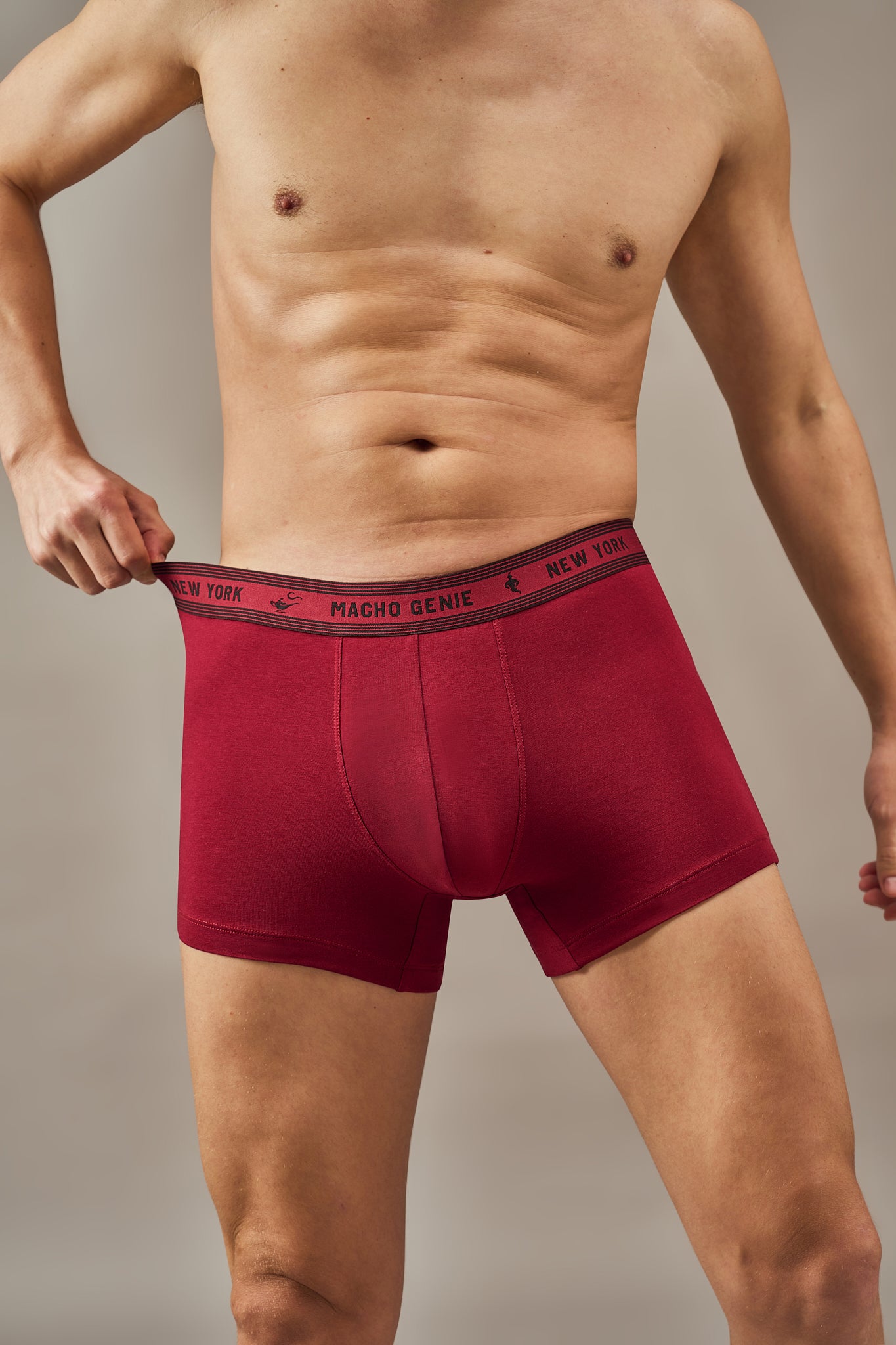 Macho Genie Bold Impressions men's trunk underwear close-up showing the finished seam pouch, supportive construction, flexible waistband, and soft cotton feel in ruby red