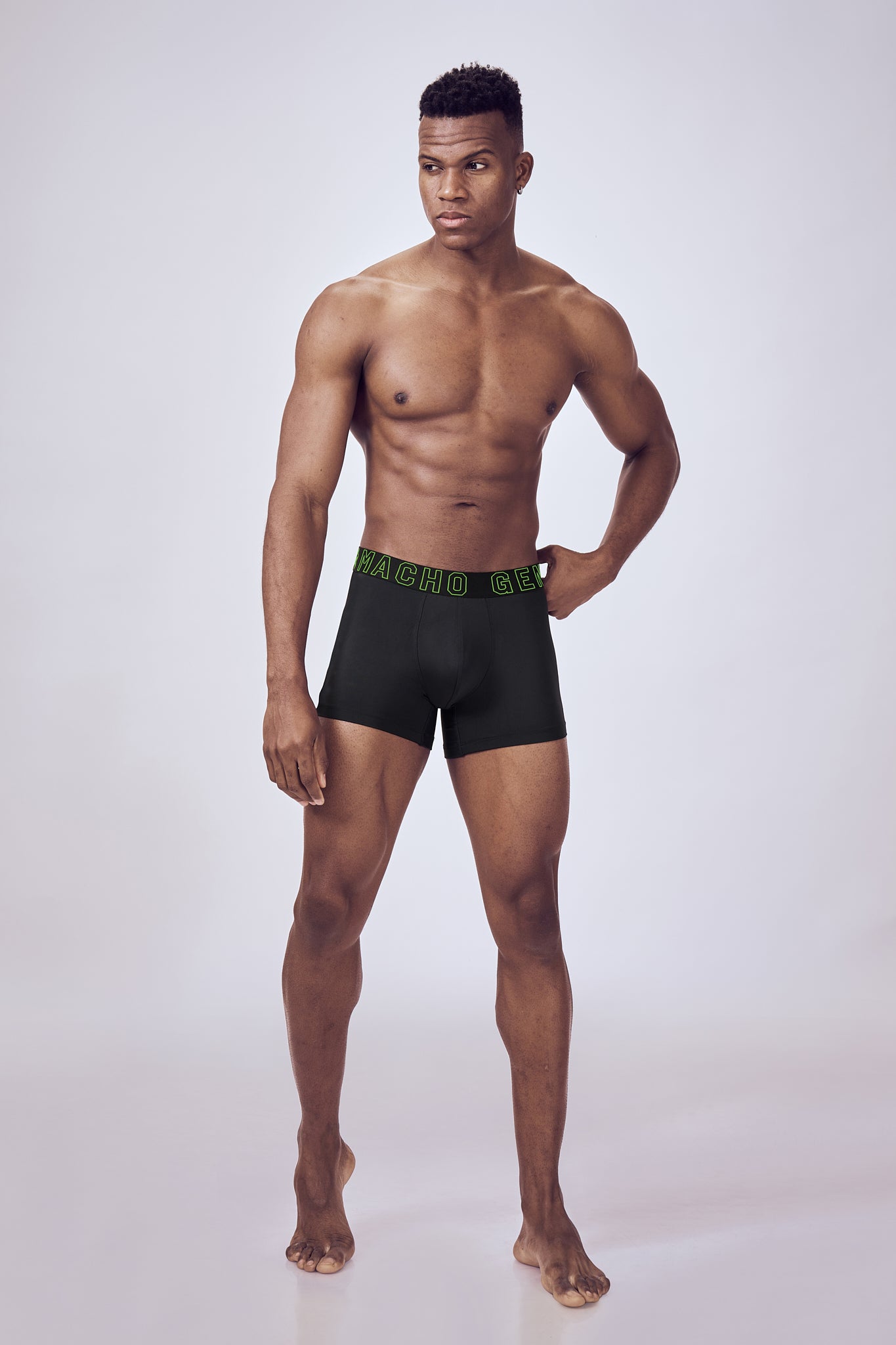 Macho Genie Black Performance Compression Trunks shown in a full-body close-up, highlighting the athletic silhouette and close-fitting design