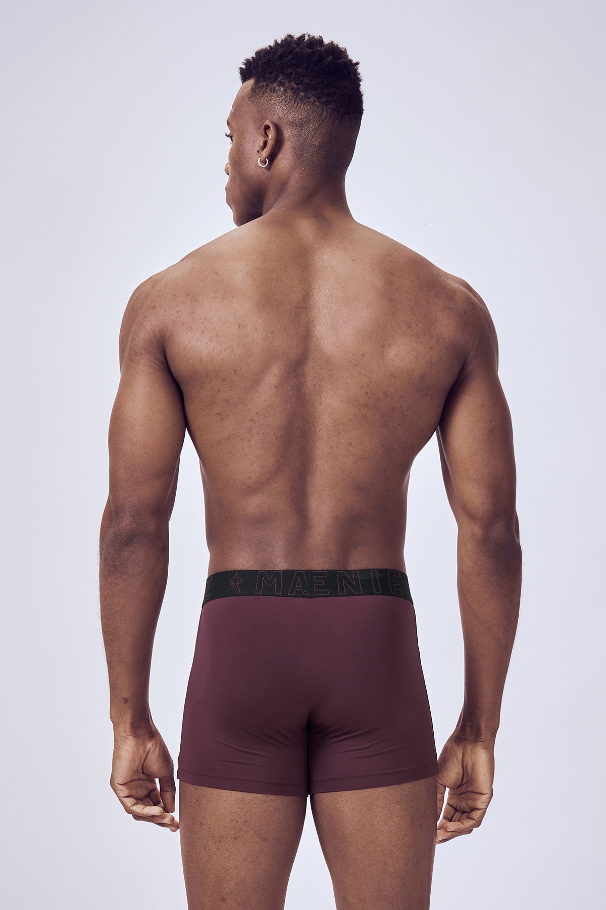 Macho Genie Wine Performance Compression Trunks shown from the back, featuring a close-fitting compression design and flexible waistband for active movement