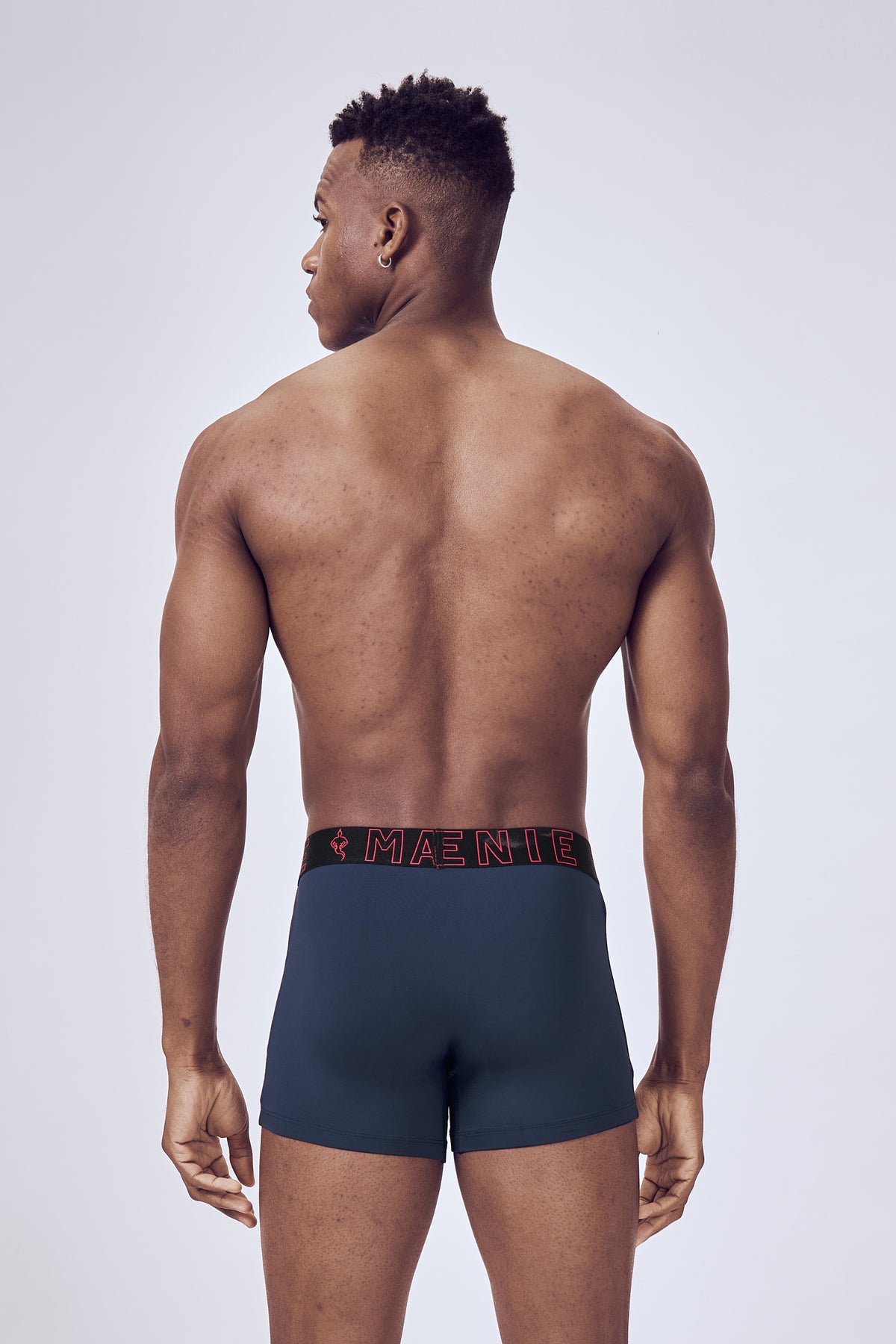 Macho Genie Blue Evercore Performance Compression Trunks shown from the back on a male model, highlighting the rear fit, smooth coverage and flexible waistband