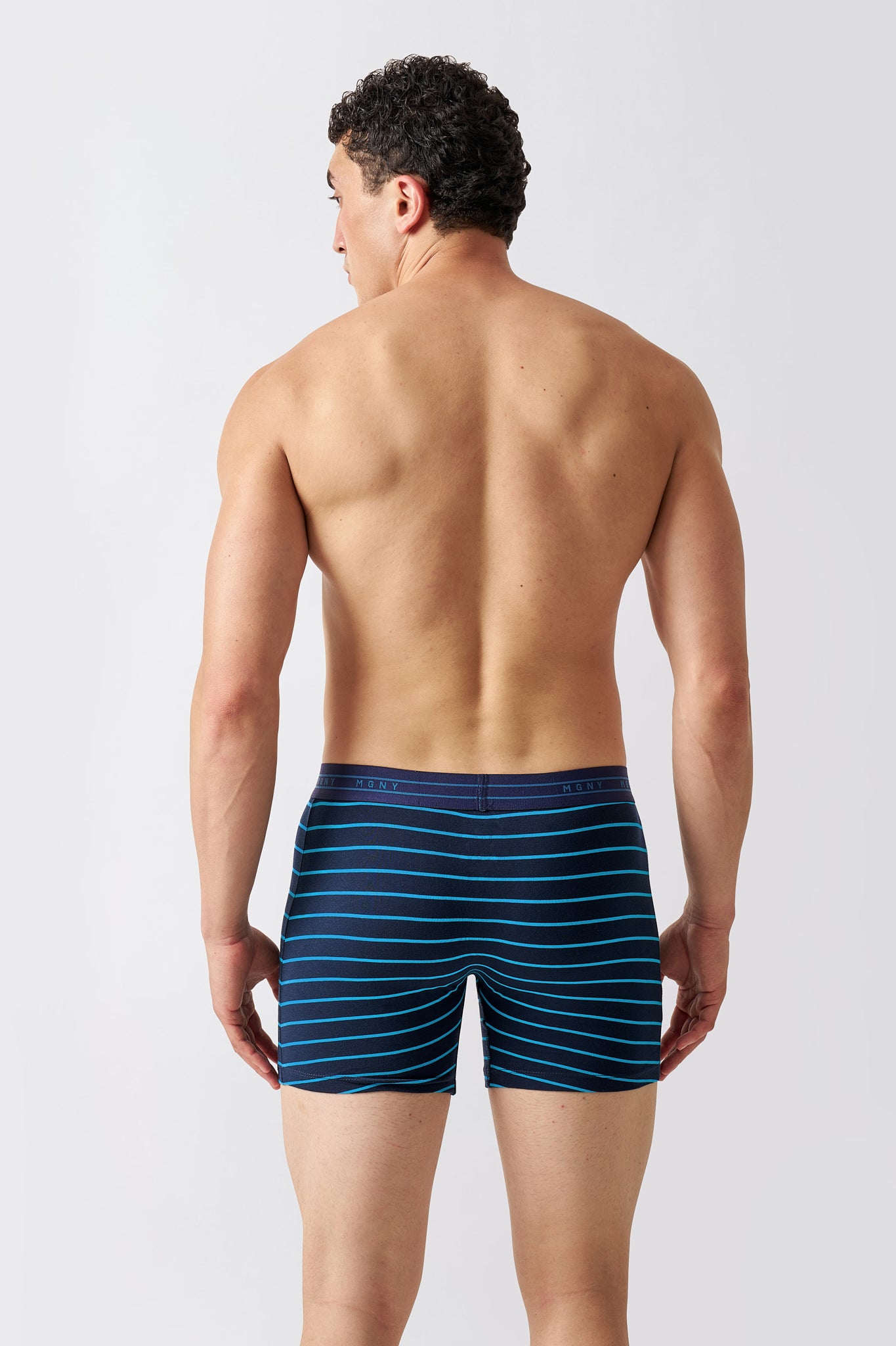 Macho Genie Luxe Stripe men's blue striped boxer briefs shown from the back with horizontal stripe detailing and cotton underwear fabric