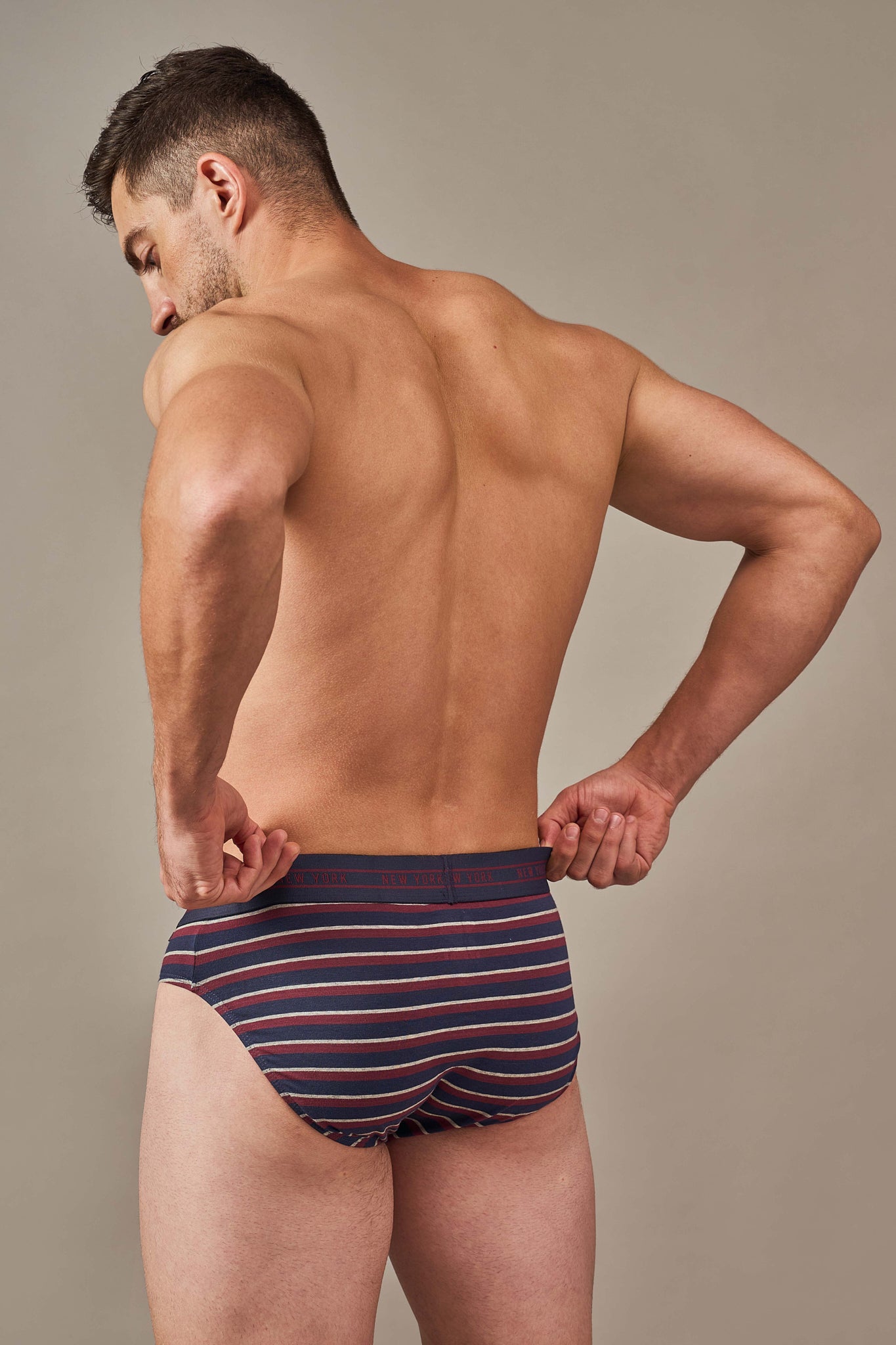 Back view of men's navy and burgundy striped cotton briefs with full coverage and a stay-put fit