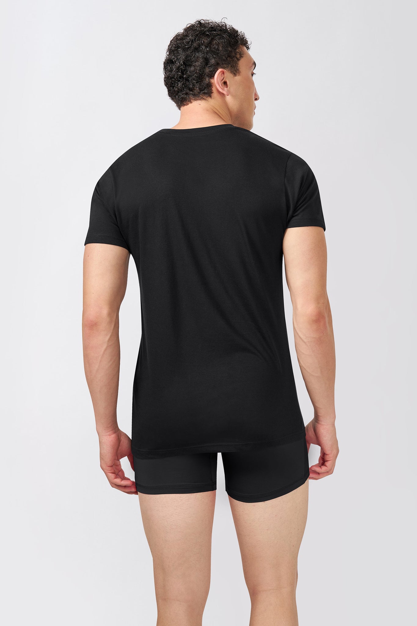 Macho Genie AeroCot Base+ men's black round neck undershirt shown from the back, highlighting the clean fit and full back coverage