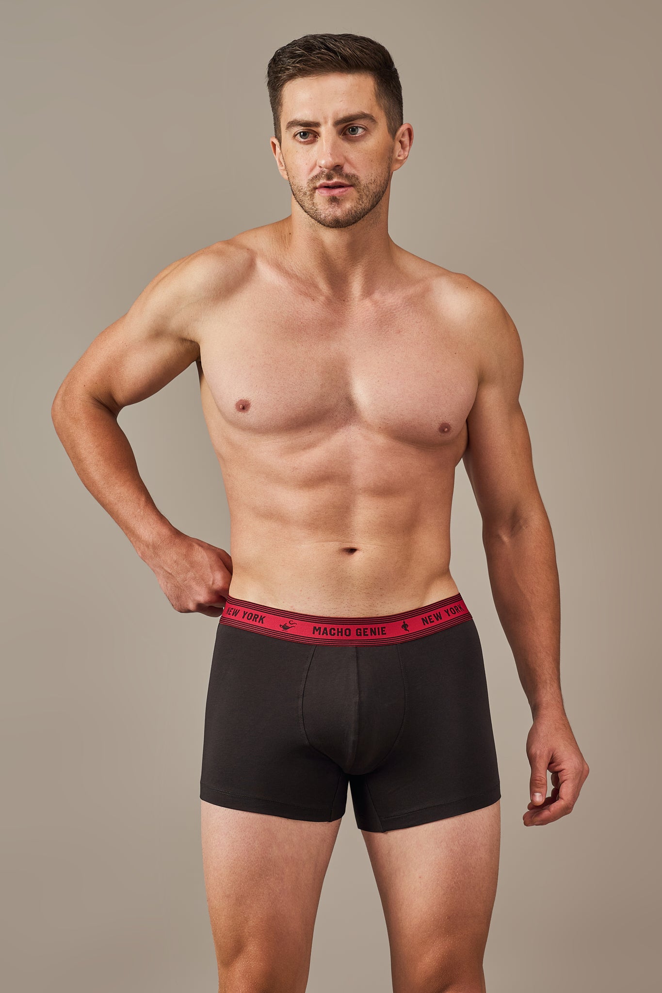 Macho Genie Bold Impressions men's cotton trunks shown from the front with a contoured pouch, 3-inch inseam, and supportive stretch waistband in Black