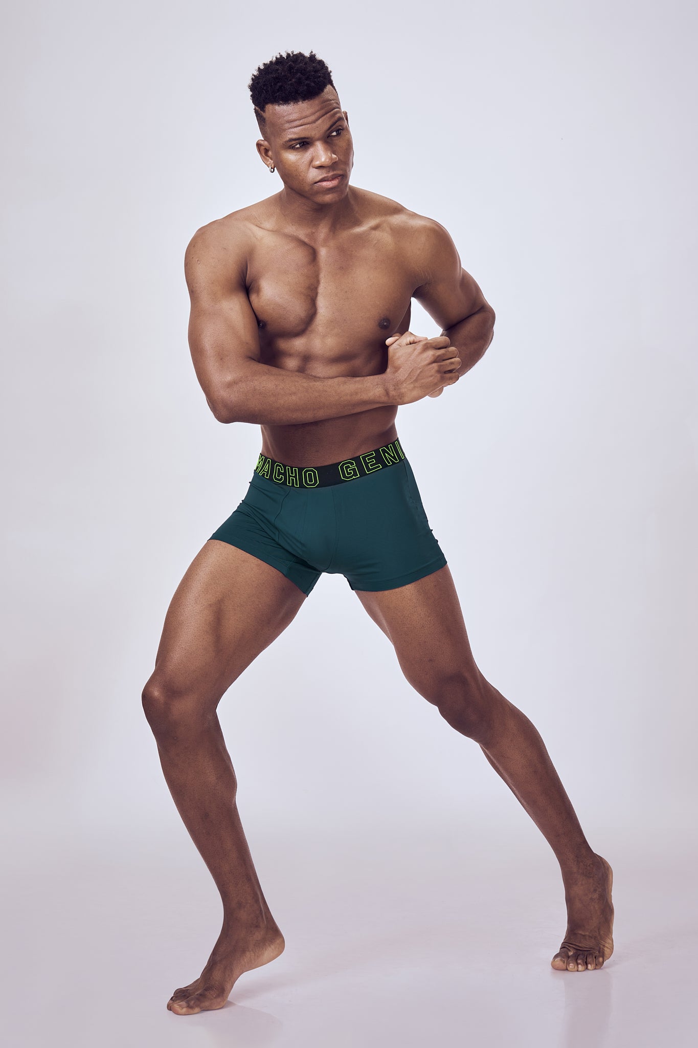 Macho Genie Evercore Performance Compression Indigo Trunks worn by a male model, showcasing the athletic fit, stretch construction, and streamlined profile