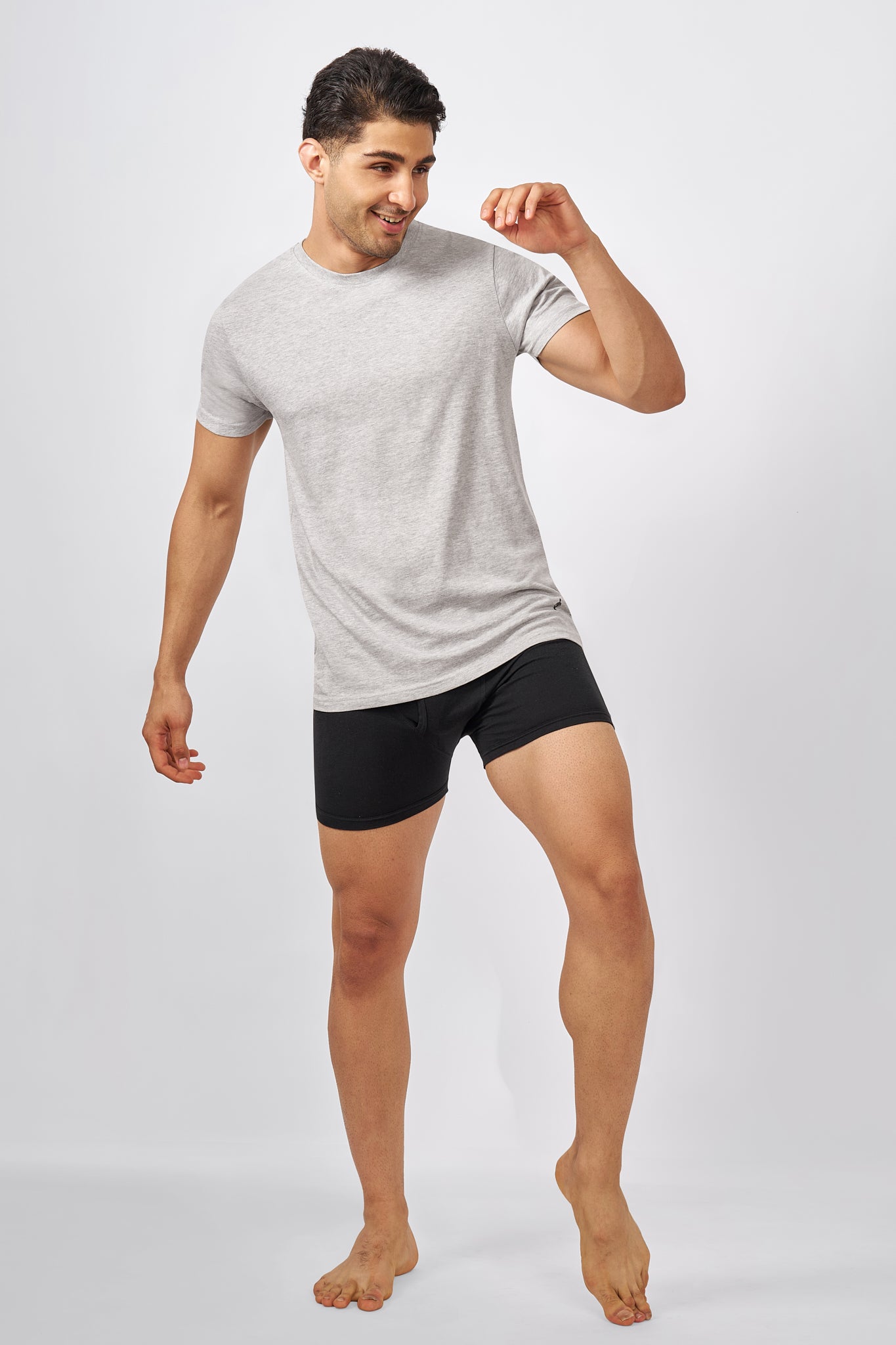 Macho Genie AeroCot Base+ grey crew neck men's undershirt can be worn during relaxed movement, showing its comfortable short sleeve fit and easy everyday wear