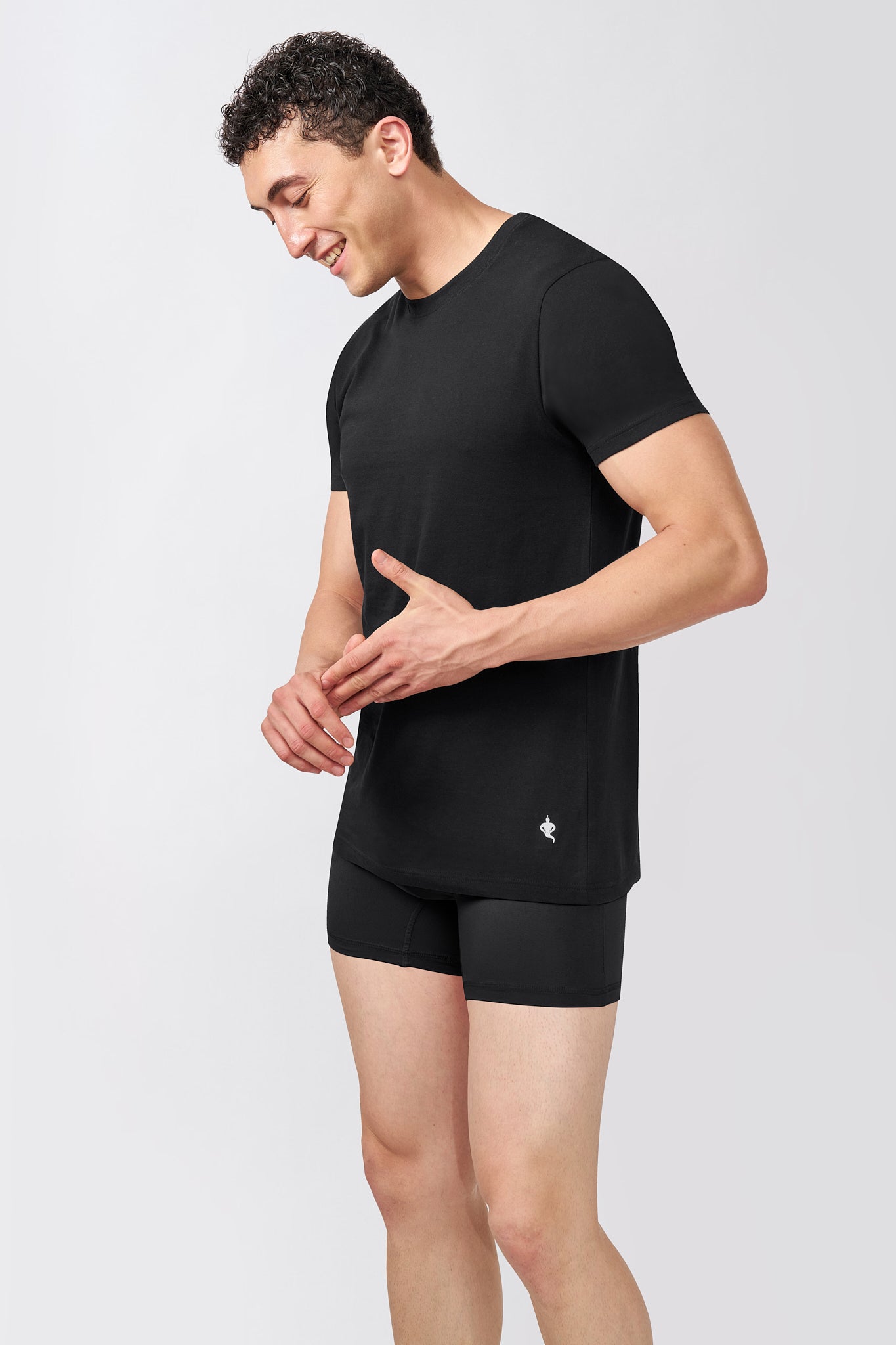 Macho Genie AeroCot Base+ men's black round neck undershirt shown from the side, highlighting the short sleeves and streamlined everyday fit
