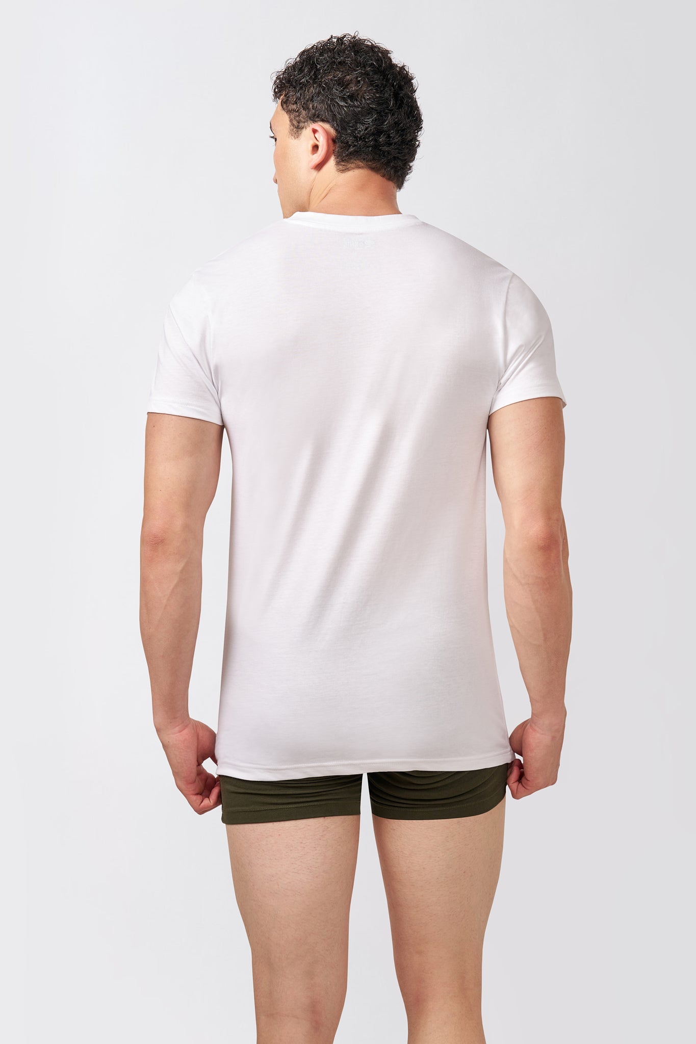 Back view of the Macho Genie AeroCot Base+ men's solid white cotton V-Neck undershirt showing the full-length fit