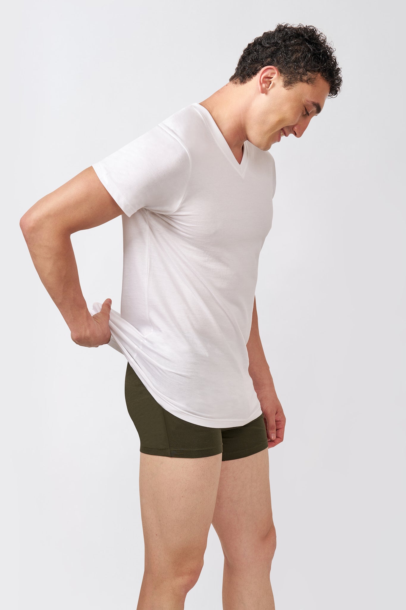Side profile of a Macho Genie AeroCot Base+ men's white V-Neck undershirt showing its fitted short-sleeve silhouette