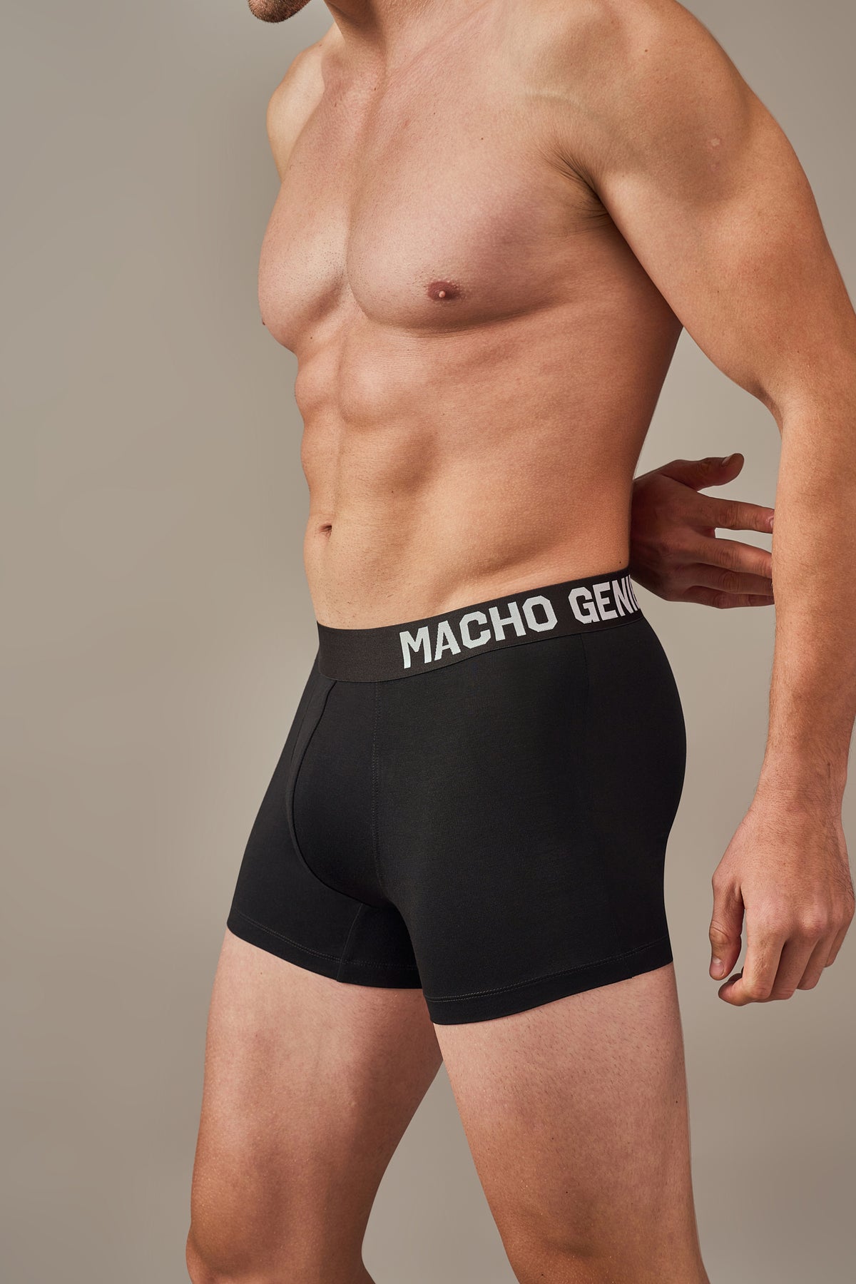 Macho Genie premium black modal trunks shown in a close-up, highlighting the flexible waistband, ultra soft bio washed modal fabric and tailored 3 inch seam.