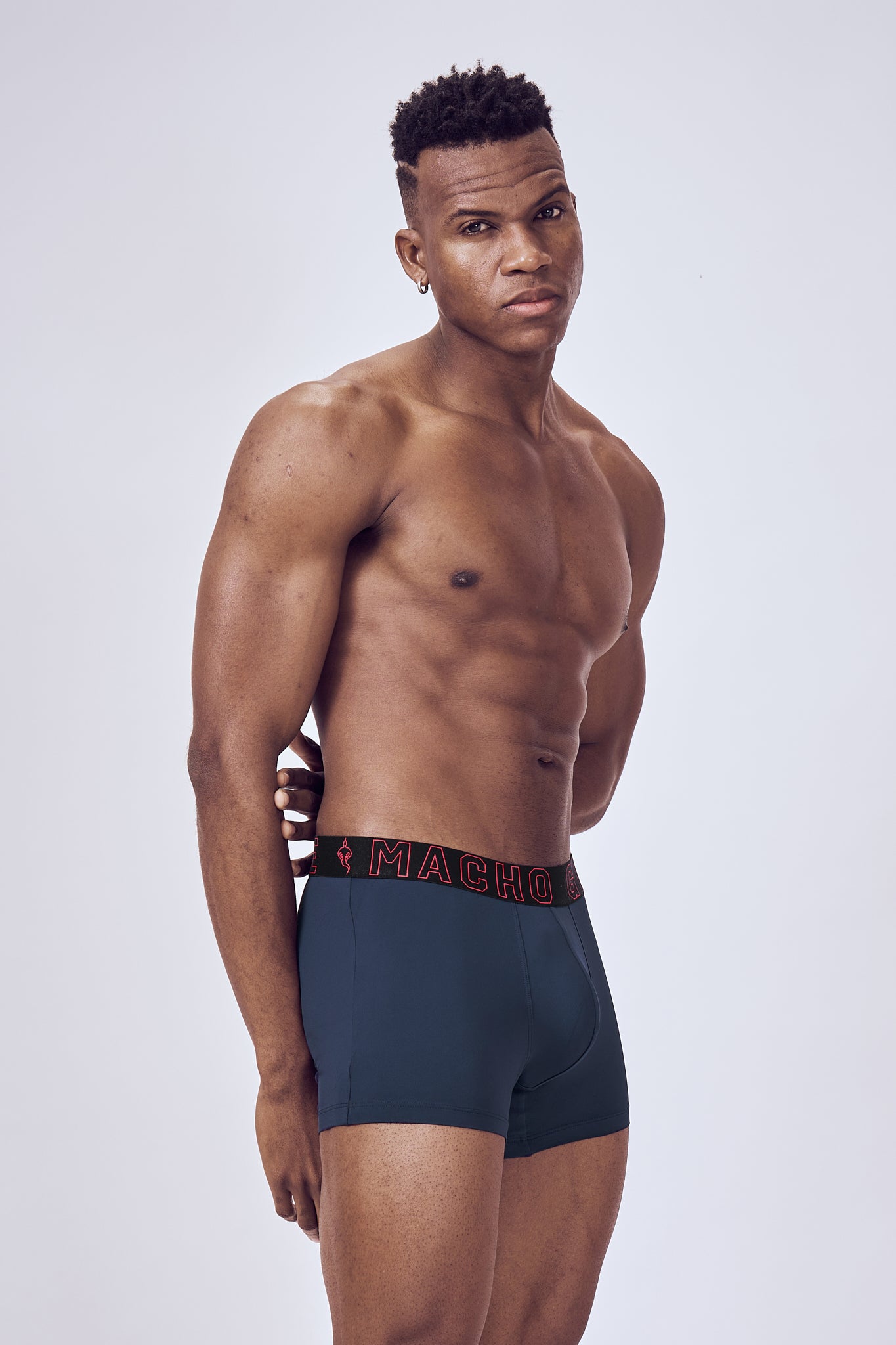 Macho Genie Performance Compression Blue Trunks shown from the side, highlighting the streamlined profile, close-fitting construction and flexible stretch waistband
