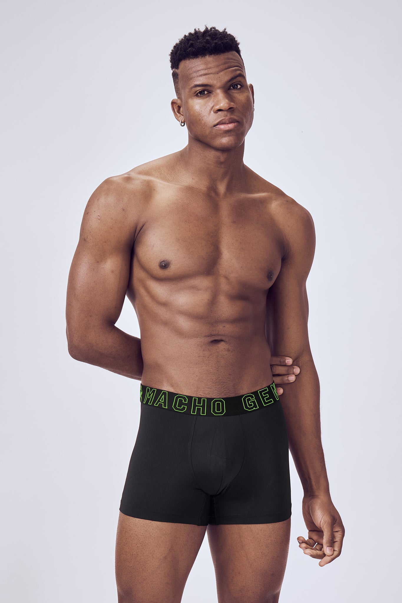 Macho Genie Black Performance Compression Boxer Trunks shown from the front, featuring moisture-wicking performance fabric and a close-fitting athletic silhouette