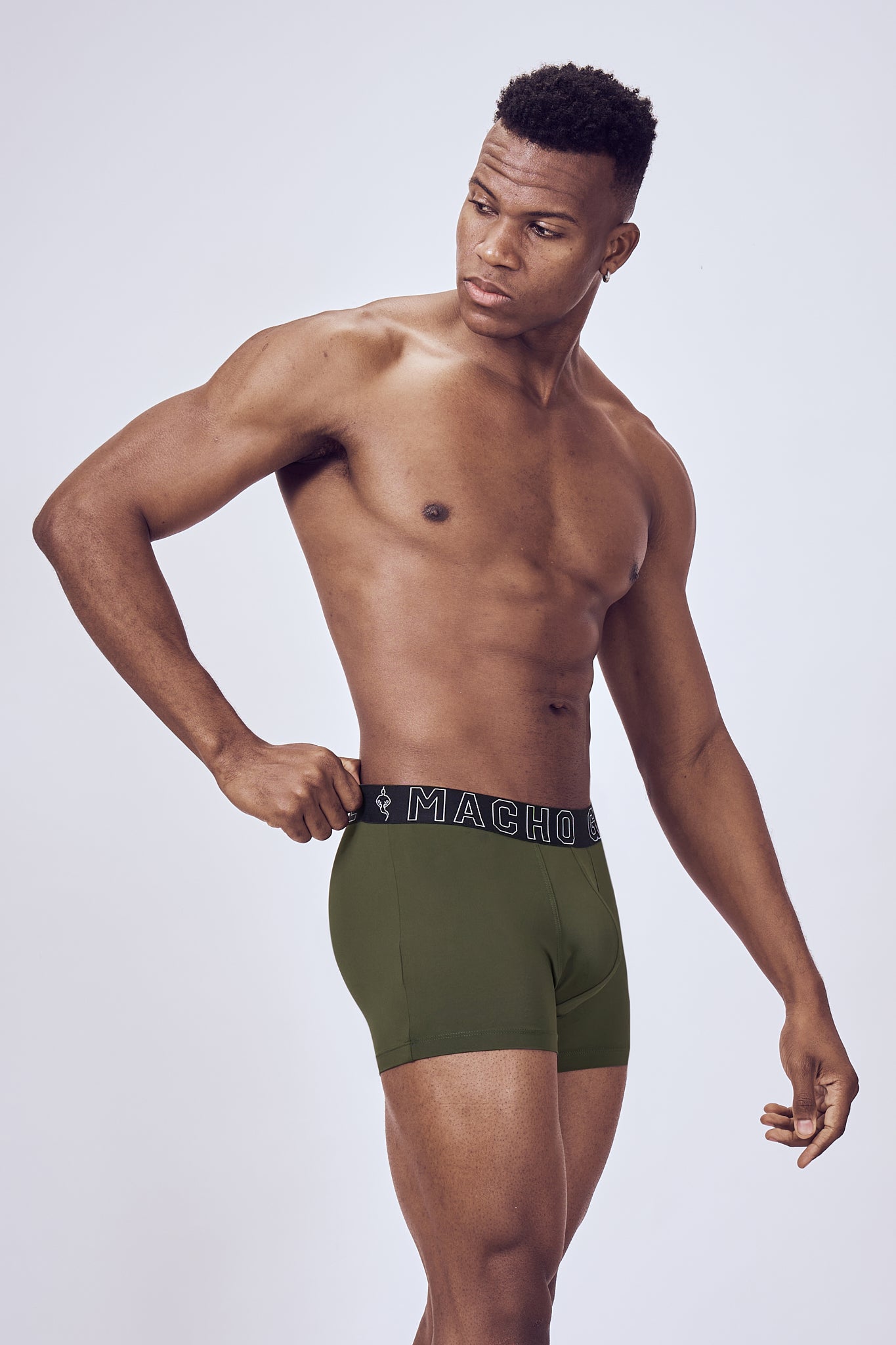 Macho Genie Evercore Performance Compression Green Trunks shown in a close-up view, highlighting the flexible waistband and streamlined athletic design
