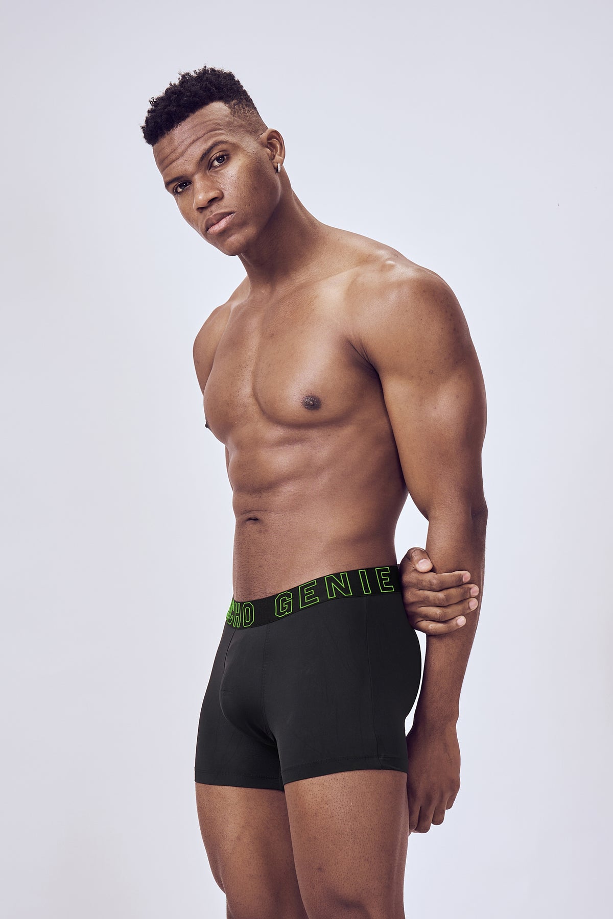 Macho Genie Performance Compression Black Boxer Trunks shown from the side, showcasing the streamlined athletic profile and flexible construction
