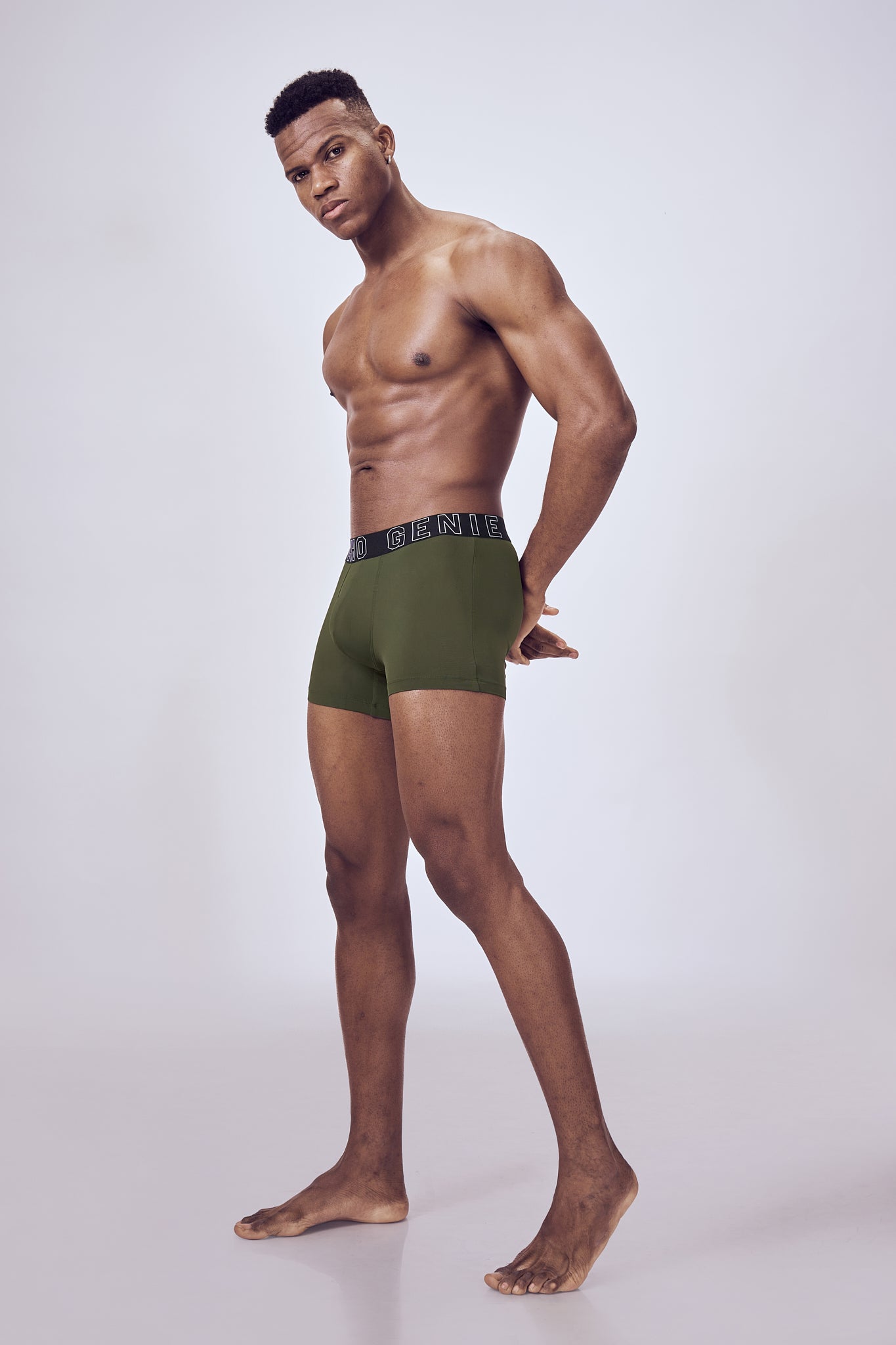 Macho Genie Performance Compression Trunks in green color shown from side view, featuring a fitted compression design and flexible stretch waistband