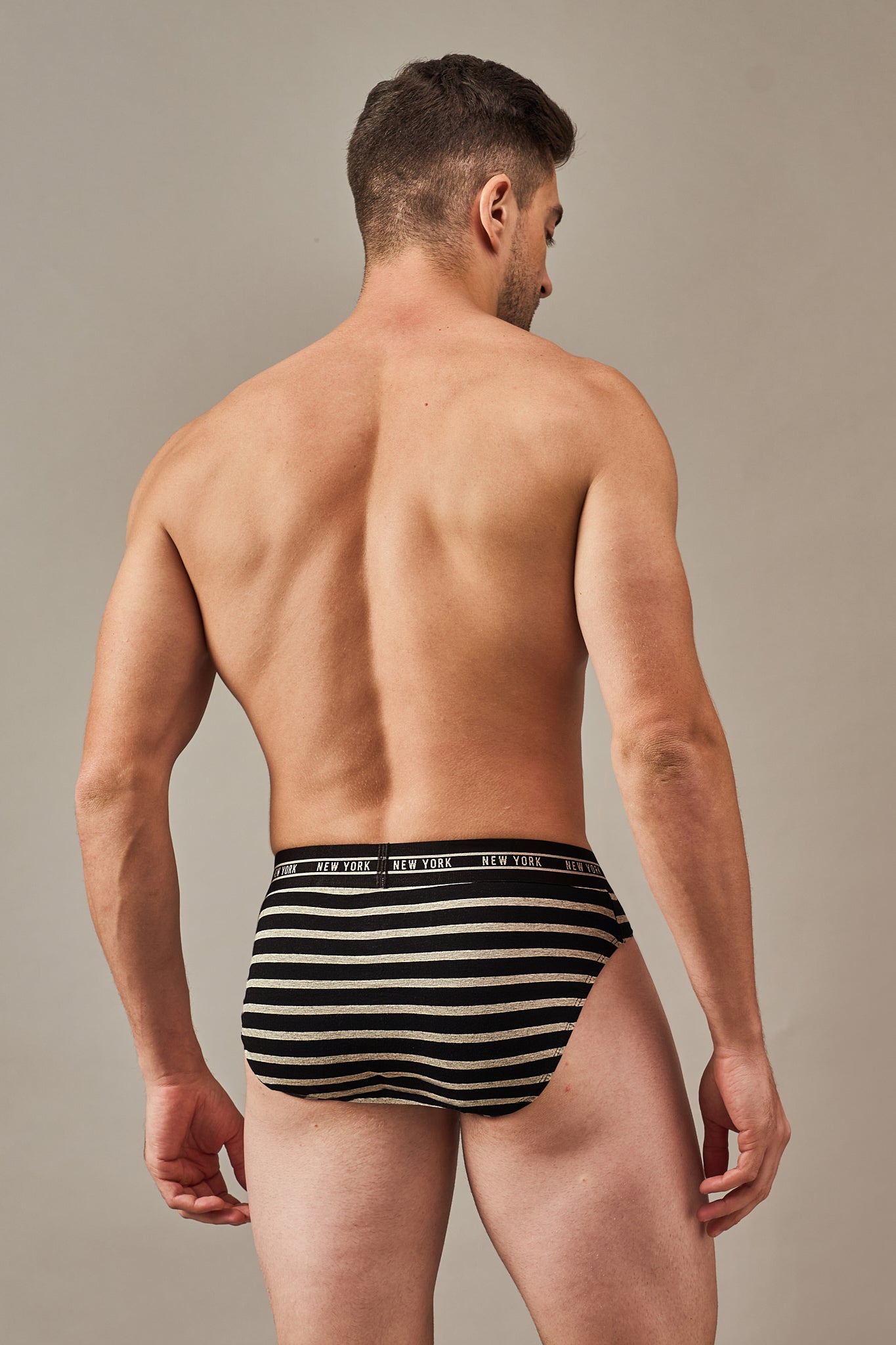 Back view of men's black striped cotton briefs with a stay-put waistband
