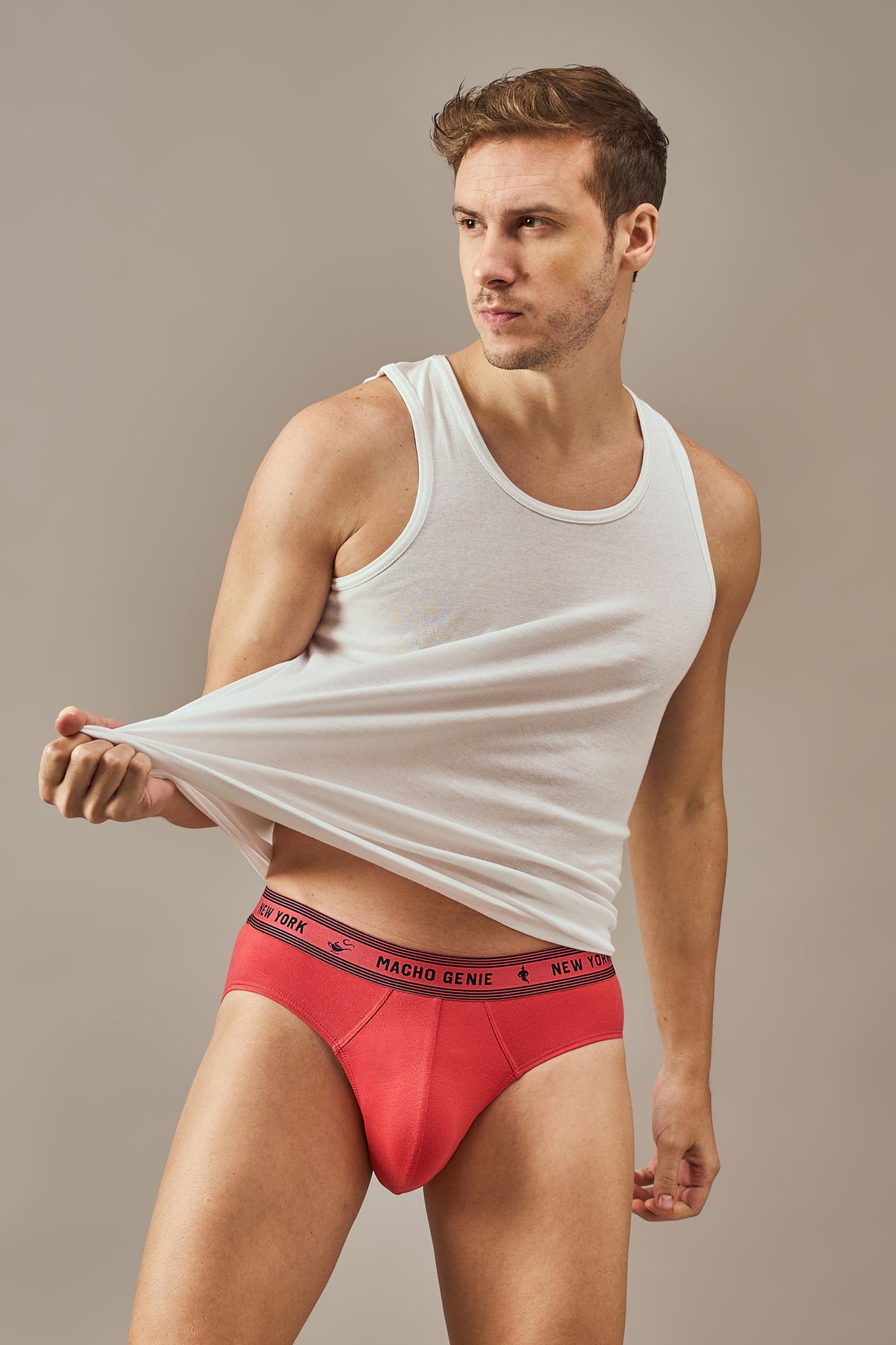 Macho Genie Men's Essentials Bold Impressions Y-shaped cotton brief shown in a close fit view featuring the finished pouch seam and branded waistband in Ruby Red