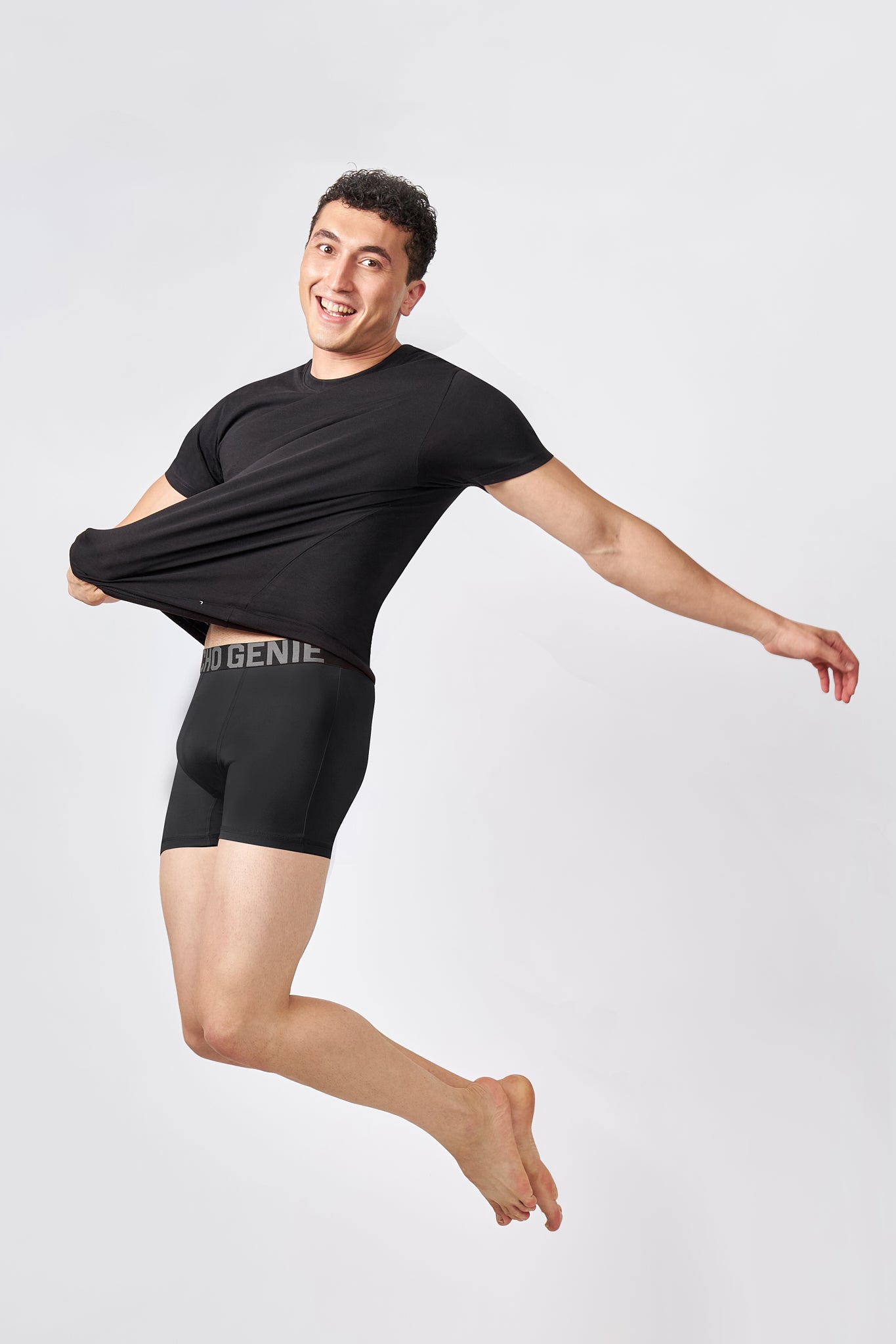 Macho Genie AeroCot Base+ black round neck undershirt stretched during movement, showing the flexible fit and comfortable everyday construction